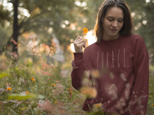 Load image into Gallery viewer, Woman wearing a Mushroom Forager sweatshirt standing in wildflowers